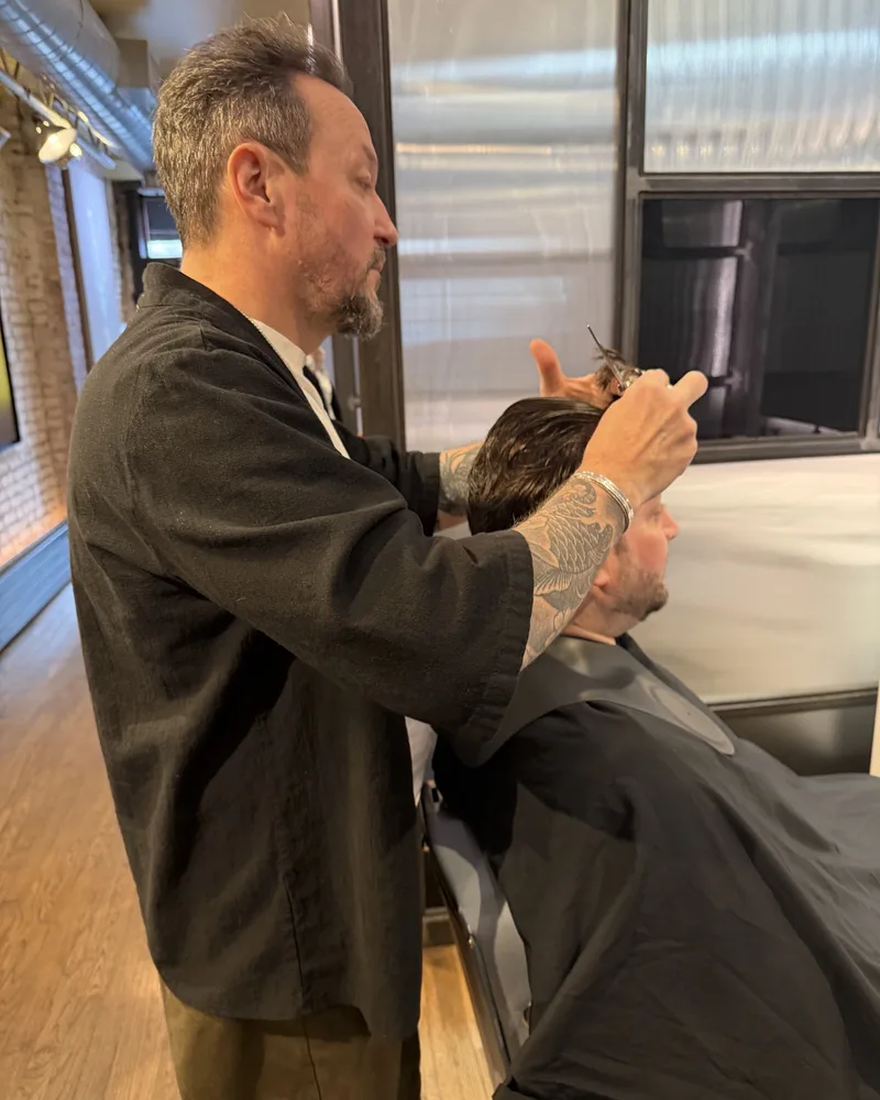 A stylist styling a guest’s hair by hand at the Martial Vivot West Village salon