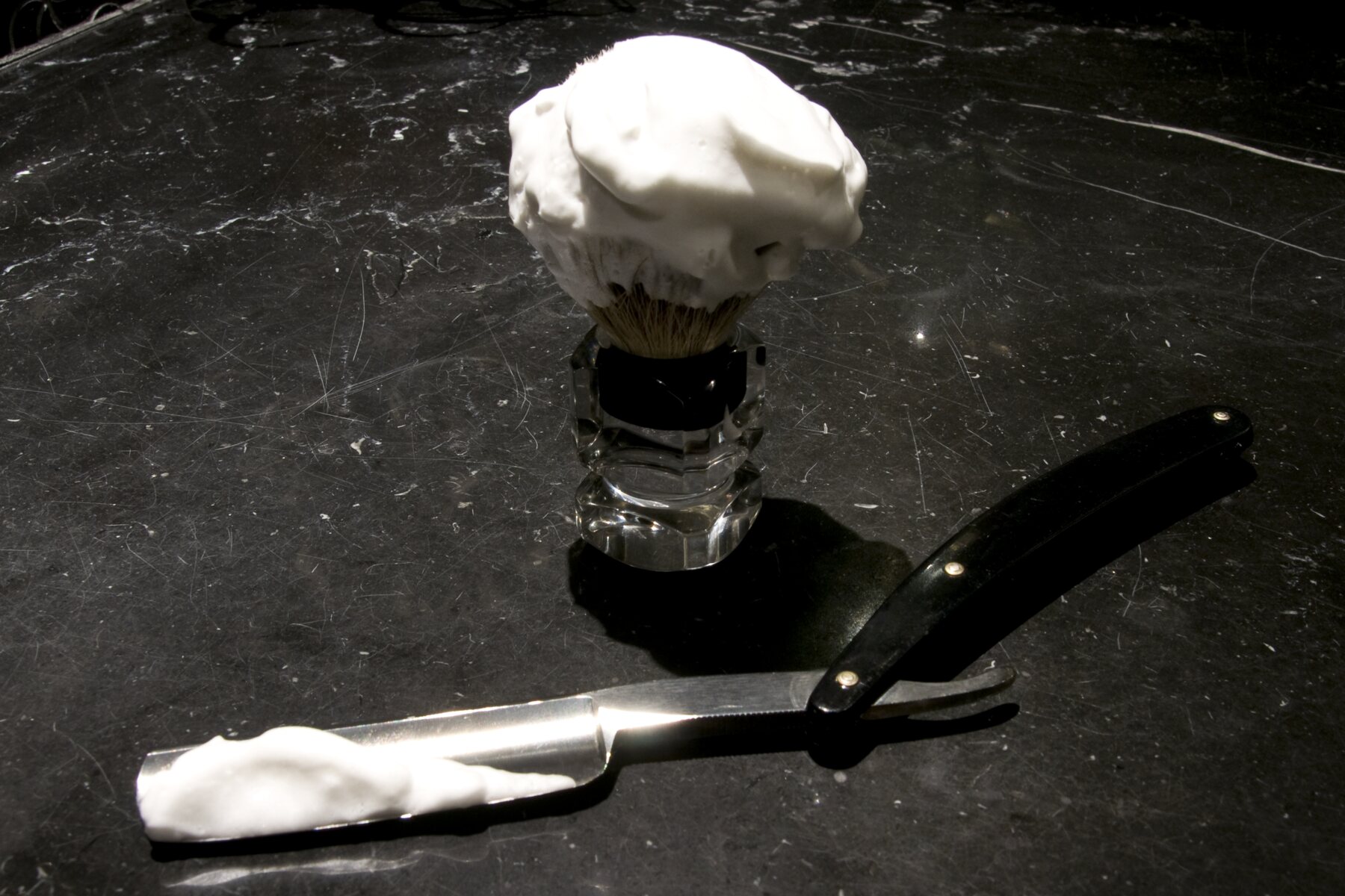 A straight razor and shaving brush — the straight-razor shave at Martial Vivot