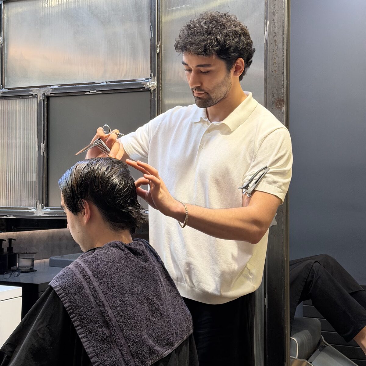 A Martial Vivot stylist scissor-cutting a guest’s hair at the West Village salon