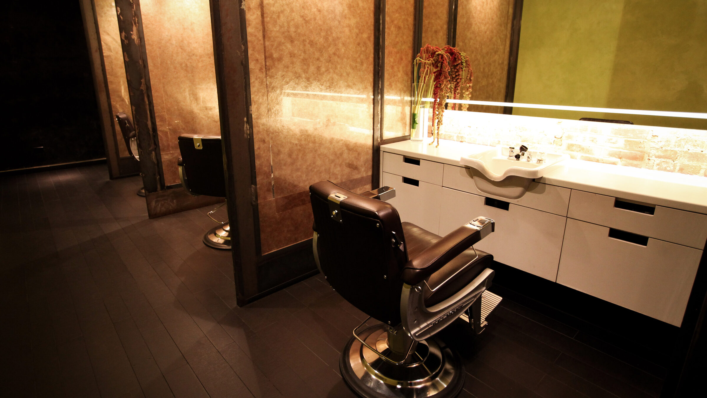 Inside Martial Vivot — a private styling station with a vintage barber chair and the salon's signature laser-cut screens