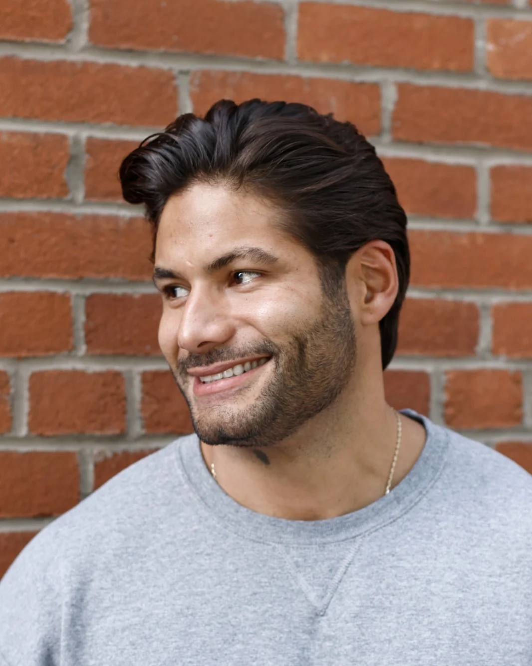 A guest with a mid-length swept-back cut and a short shaped beard after a haircut at Martial Vivot