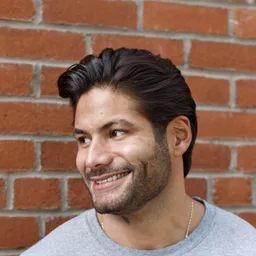 A guest with a mid-length swept-back haircut and a short, shaped beard leaving the Martial Vivot chair