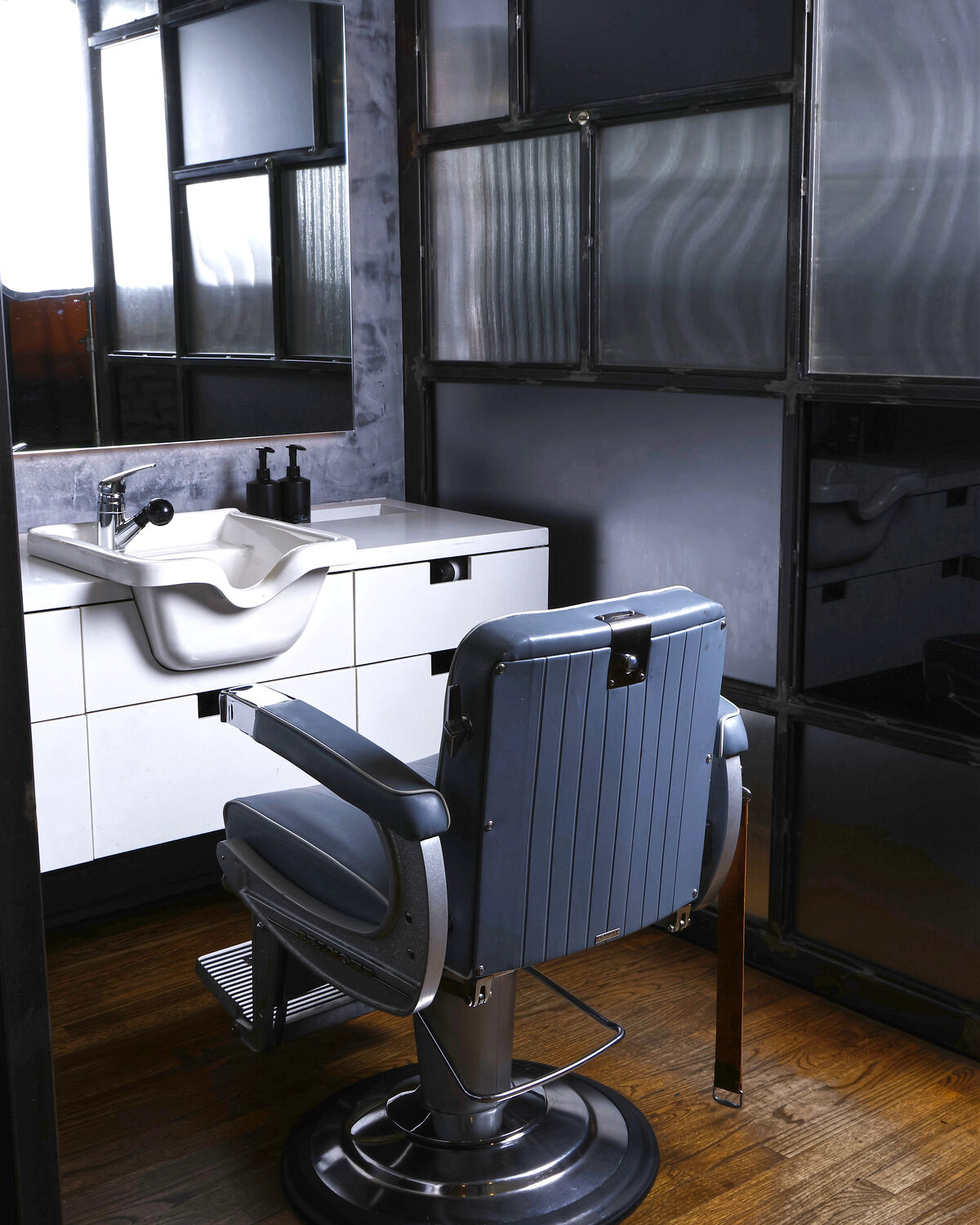 A barber chair and basin against the exposed brick at the Martial Vivot West Village salon