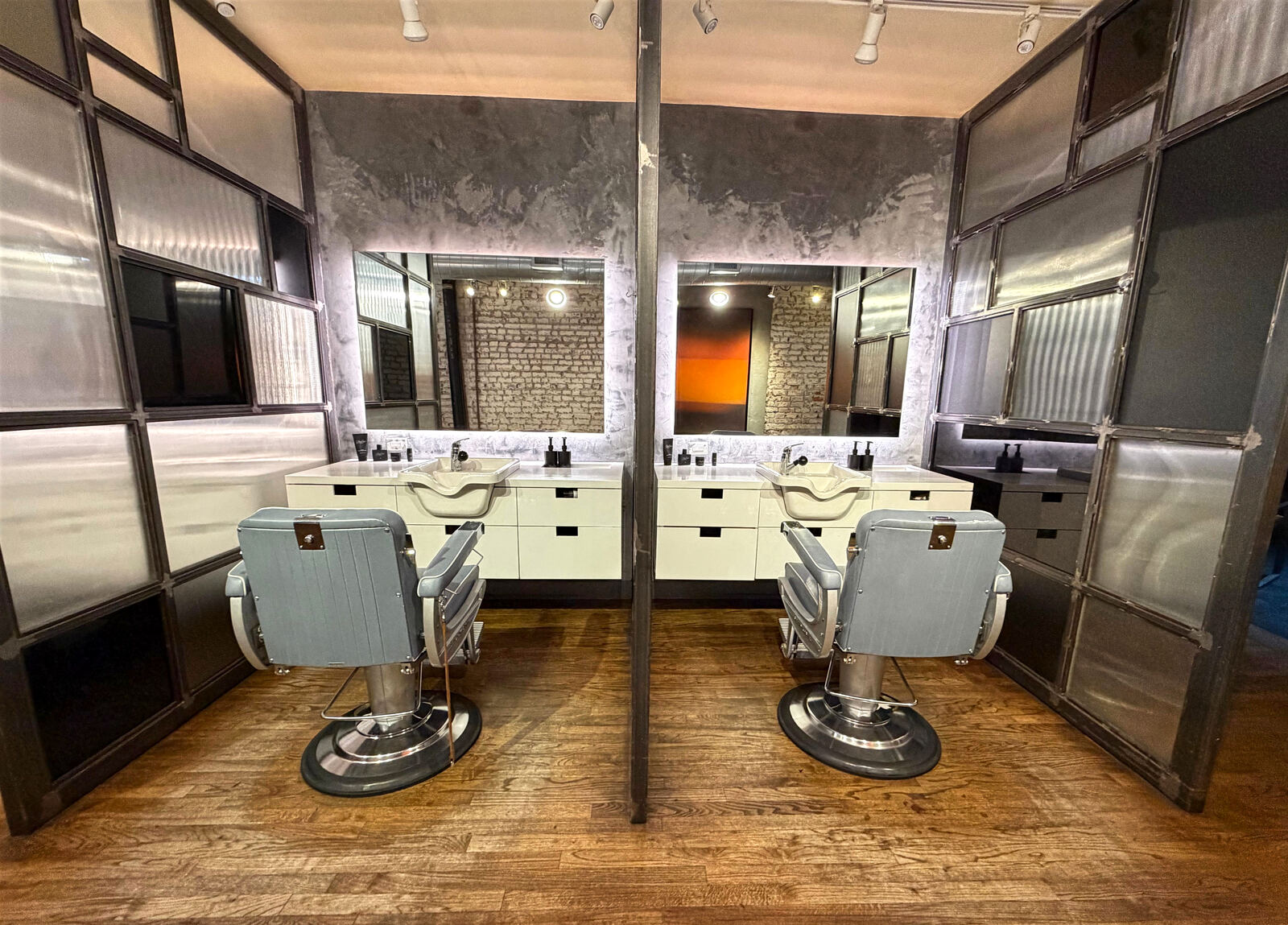 Inside the Martial Vivot West Village salon — two styling stations, mirrors and industrial-glass partitions